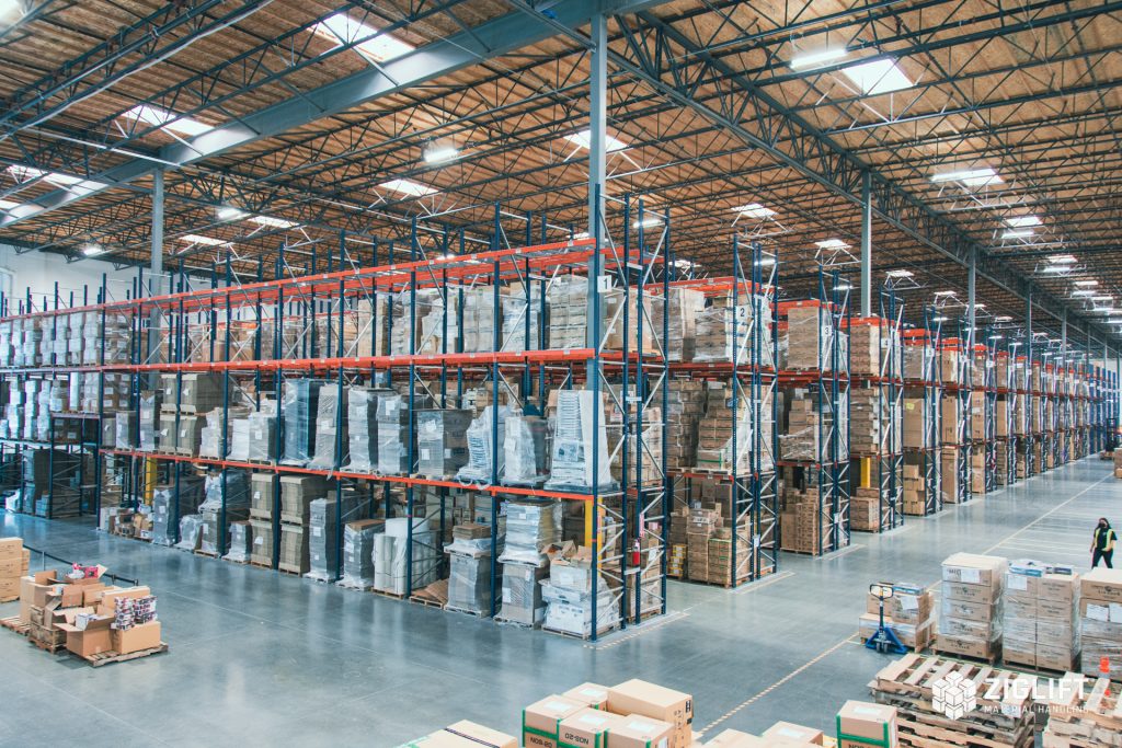 Rows of selective pallet rack with orange beams